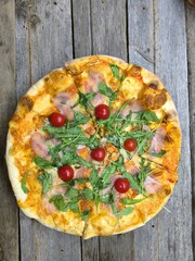 Home made pizza with cherry tomatoes and mozzarella cheese.  High-quality photo