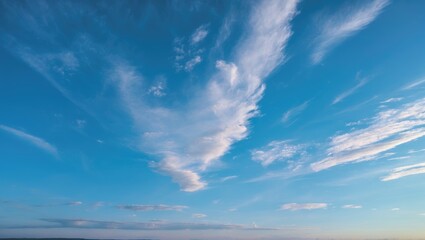 Obraz premium Vibrant morning sky with wispy clouds against a bright blue backdrop capturing the essence of tranquility and a fresh start to the day.