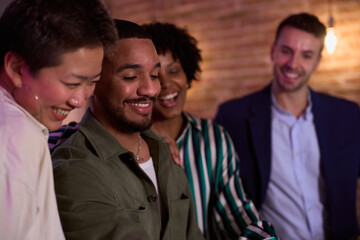 Friends smiling and having fun together at a bar