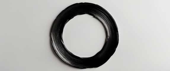 Black brush stroke circle texture on a white background ideal for artistic designs or creative projects.