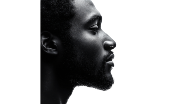 Profile view of a man against a white backdrop