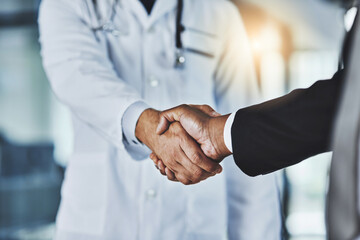 People, handshake or doctor with business for partnership, medical funding or health campaign....