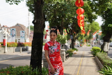 Obraz premium Woman in Red Cheongsam Surrounded by Lanterns