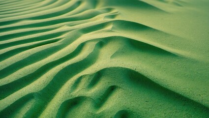 Fototapeta na wymiar Desert landscape featuring vibrant green sand patterns and natural textures creating an abstract background for creative projects.