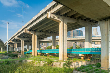 Concrete structure and asphalt road space under the overpass in the city