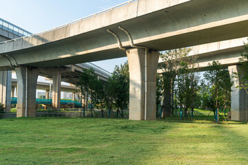Concrete structure and asphalt road space under the overpass in the city
