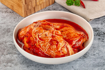 Raw chicken marinated thighs with skin