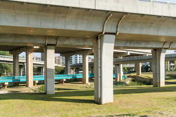 Concrete structure and asphalt road space under the overpass in the city