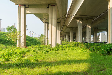 Concrete structure and asphalt road space under the overpass in the city