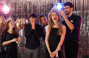 Young people crowning queen on prom night