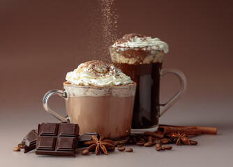 Hot chocolate and coffee with whipped cream sprinkled with chocolate crumbs.