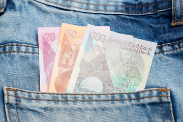 Eastern Caribbean dollar in the pocket of blue jeans