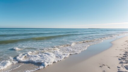 Tranquil beach scene with gentle waves lapping at sandy shore under clear blue sky Copy Space