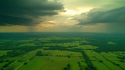 Dramatic thunderstorm clouds over lush green fields aerial landscape photography rural setting atmospheric view