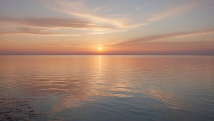 Obraz premium Tranquil sunset over calm water with reflective surface and soft clouds in the sky near horizon Copy Space