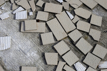 Cracked brown tiles on cement floor