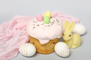 Easter cake with eggs and bunny figurine on white background