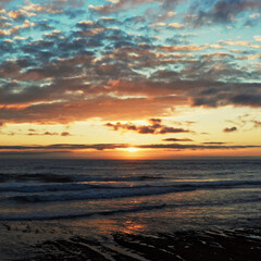 Beautiful rocky shore  with sun during sunset.  Drone view over waves of the ocean during sunset.  Aerial View of rolling waves with skyline. Relax and meditation.  Oceanscape  in Portugal