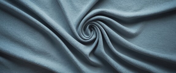Obraz premium Textured blue fabric background with swirling folds and soft surface details in natural light.