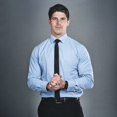 Portrait, business and man in studio, hands together and professional on gray background. Face, person and employee with confidence, pride and accountant for corporate company and tax review