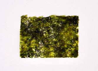 One piece of crispy seaweed snack isolated on horizontal white background from top angle view. © Amanda Alamsyah
