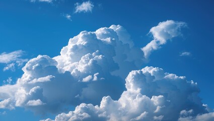 Fluffy white cumulus clouds in a clear blue sky during daytime natural landscape background.