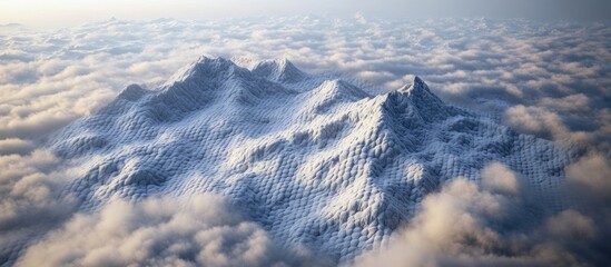 Aerial view of majestic snowy mountains shrouded in low clouds at dusk with soft blue and gray tones creating a serene atmosphere.