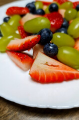 Plate with strawberry, blueberry and grape