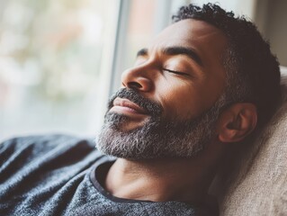 Obraz premium A man enjoying a peaceful moment of relaxation on a cozy sofa 