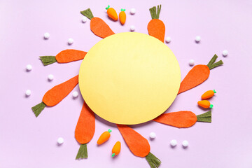 Easter paper carrots and blank greeting card on lilac background. Top view