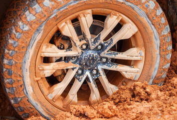 A tire stuck in the mud on a dirt road on a village road. Off-road trips are loved by adventurers