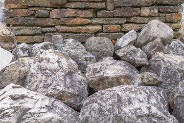 Big stones near ancient brickwall