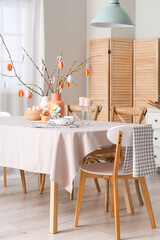 Stylish interior of dining room with Easter table setting