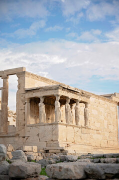 Erechtheion temple with Caryatid statues under a blue sky in Athens