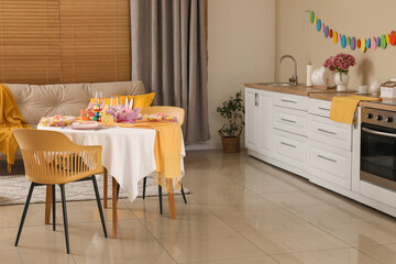 Interior of modern kitchen with festive table serving for Easter celebration