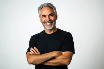 Smiling middle aged man with his arms crossed, wearing a black t shirt on white background.