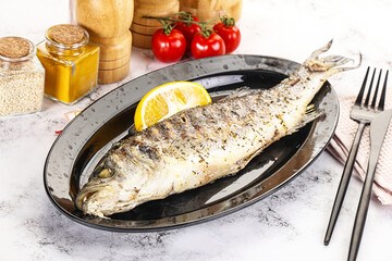 Grilled sea bass fish served lemon