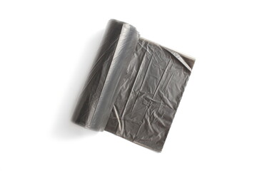 There is a black garbage bag on a roll on a white background.