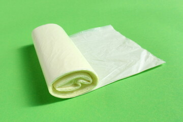 Fototapeta premium There is a roll of yellow garbage bag on a green background. 