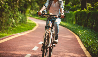 Fitness woman cycling in the park