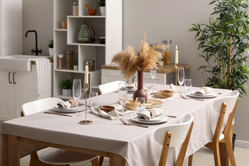 Stylish table setting for dinner in kitchen