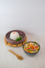 Savory Beef Rib Soup With Colorful Vegetables In A Bowl And Steamed White Rice Garnished With Chili And Fresh Parsley Ready For A Delicious Meal.