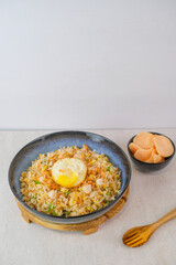 Delicious Of Indonesian, Kampung Fried Rice Topped With Perfectly Fried Egg, Aromatic Fried Shallots, And Crispy Crackers For A Comforting Meal.