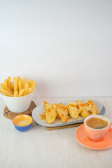 Fried Cassava Sticks, Cheesy Fried Banana With Grated Cheese And Powder Topping, Served With Creamy Cheese Sauce And A Hot Cup Of Americano Coffee.