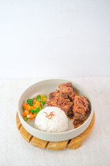 Grilled Beef Ribs With White Rice And Steamed Vegetables In Ceramic Bowl On Wooden Tray For Traditional Indonesian Cuisine Presentation.