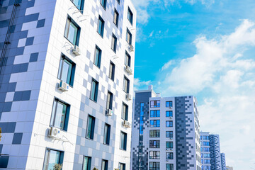 Fototapeta premium The concept of modern architecture, residential complex, apartment buildings for living. The camera moves smoothly along a multi-storey, multi-apartment residential complex of modern architecture in