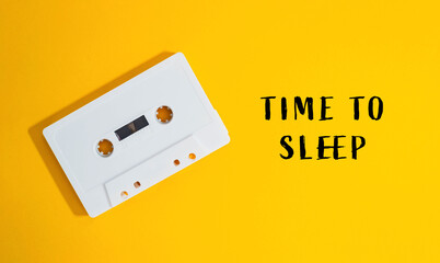 White cassette tape is on a yellow background with the words Time to sleep