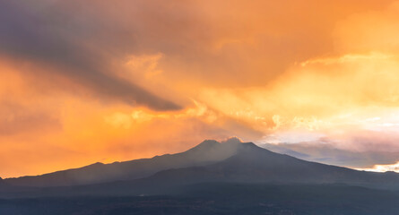 beautiful panorama of volcano mountain during evening synset with twilight clouds and shadows above majectic mountain and amazing cloudy sunset sky on background