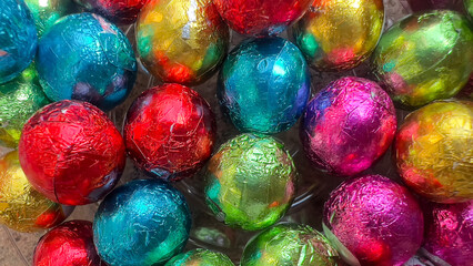 Colorful chocolate cubes background, glossy texture, abstract background.