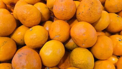 Fresh oranges with bright, juicy flesh, sliced and whole, arranged on a wooden surface. The citrus fruit is rich in vitamin C and antioxidants, perfect for healthy eating, refreshing drinks natural